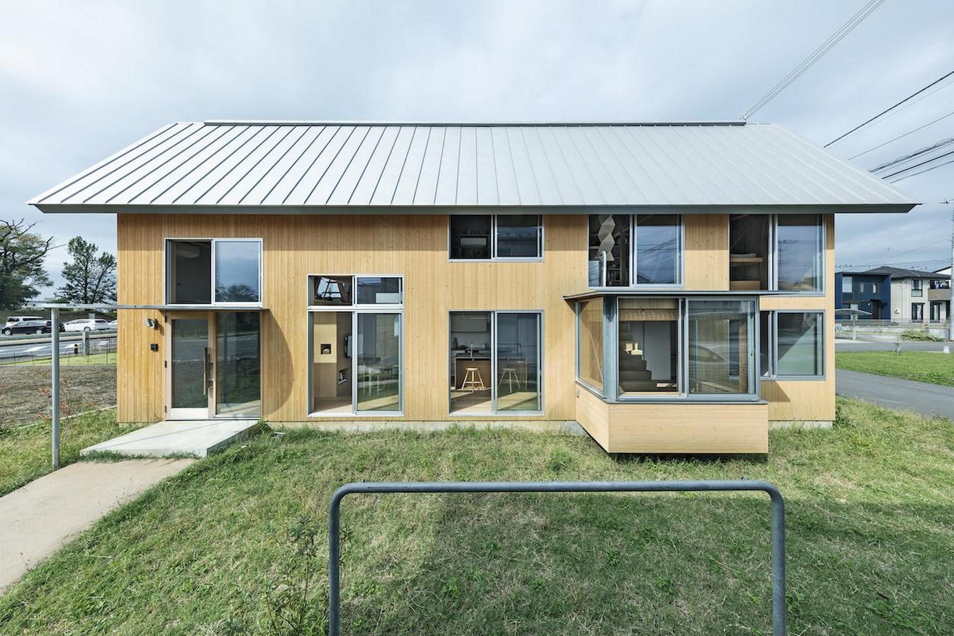 House in field' containing variety of living spaces beneath its gable roof designed by Ship Architecture - Sheet1