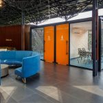 PROJECT INFORMATION Project Name: Experience Centre Location: Koyembedu, Chennai Site Area: 0.75 Acre Built-up Area: 0.20 Lac sft No of Floors: 1 Status: Completed Year of Completion:2021 Firm: CnT Architects Design Team (CnT): Amit Rastogi, Karthik P Nair, Anupama Rao Consultants: Metal Queen (Structure), Mukund Associates (Plumbing), Lite Lab (Lighting Design), Oikos (Landscape), Graphics Beyond (Graphic Design) Photography: Andre Fanthome INTRO (470 Words) Located in Chennai metropolitan at a close proximity to city’s transit hub, the site is approached from a highly buzzing Poonamalli high road. Three key components- A marketing office, an Experience centre and a Construction site office are the core of the facility. ‘‘Journey through the project reveals intricately detailed spatial sequences carefully crafted by the thoughtful blend of Architecture, Landscape and Interior design. Visual frames and experiences unfold in layers to keep the visitor captivated & intrigued throughout.’’ A landscaped plaza creating a tranquil arrival experience is first on the entry sequence; doubling up as the interface between city and the main program filtering the unwanted external buzz. At point of arrival, one gets a glimpse of Intricate roof canopy of marketing office hovering over plaza feature wall, creating a sense of mystery for what lies ahead. ‘Marketing office’ is accessed through a curved alley; meandering through lush green it guides visitors to an arrival court revealing full view of the architecture. The form; conceived as an expansive canopy floating over slender metal columns shelters many pods beneath to hold the programme. Pods contain air-conditioned spaces for the reception, gallery, media room, customer studios etc. Arranged in a free plan form, their placement defines a natural movement spine along the longitudinal axis. Intricate design of ceiling and series of skylights along the spine enriches the experience of moving through the space. The ‘Experience centre’ is accessed through a landscape buffer placed at the end of marketing office. Steps through the landscape graduate to a scaled down movement spine representing the proportions of an apartment lobby, leading to three model apartment prototypes put on display here. Placement of model apartments is juxtaposed with various semi open and open public spaces to create a very engaging and enthralling environment. Overall visitor journey is designed as two-way experience and design features are tactfully placed along the path and at important nodes to be discovered gradually and slowly. A discreetly placed entryway at the end of experience centre leads in to the ‘Construction site office’. Encouraged to see the importance given to design of spaces for the construction team; visitors are escorted right through the common area of site office arriving on to a viewing deck opening to a panoramic view of the under construction residential township which is rising up in the background. Environmental impact: Life span of facility is five years, post which it will be dismantled. Hence, majority of the structure is designed in steel for recyclability and reuse. The modular structural elements are going to be used for another project of the developer, making this project as sustainable as possible. Circulation spaces are well shaded and allow a lot of cross breezes, essential for comfort in hot humid weather of Chennai; reducing need of air conditioning to the minimum. - Sheet12