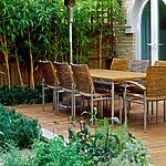 WOODEN TERRACE BESIDE HOUSE WITH TABLE AND CHAIRS PHYLLOSTACHYS VIVAX 'AUREOCALLIS' AND BOX. DESIGN : AMIR SCHLEZINGER/ MY LANDSCAPES-Sheet1